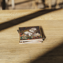 Load image into Gallery viewer, The_Boeuf_Gras_Mardi_Gras_Stone_Coaste_SquareStoneCoaster_WoodTable_AS_Mockup.png_16197001
